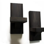 Two dark wooden wall candle holders.