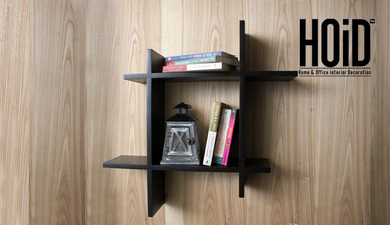 Asymmetric square floating wall shelf with books and decor.