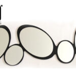 "Abstract wall-hanging mirror with oval-shaped reflections in a black frame - available in karachi."