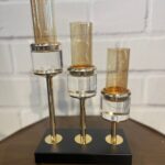 Glass candle stand with three holders.