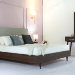 "Bedroom furniture set with a patterned bed, two side tables, one dresser, and one mirror—available in Karachi."