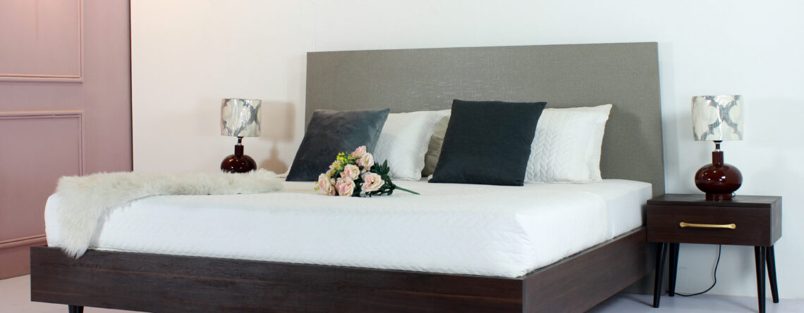 "Bedroom set featuring one patterned bed paired with two side tables – available in Karachi."