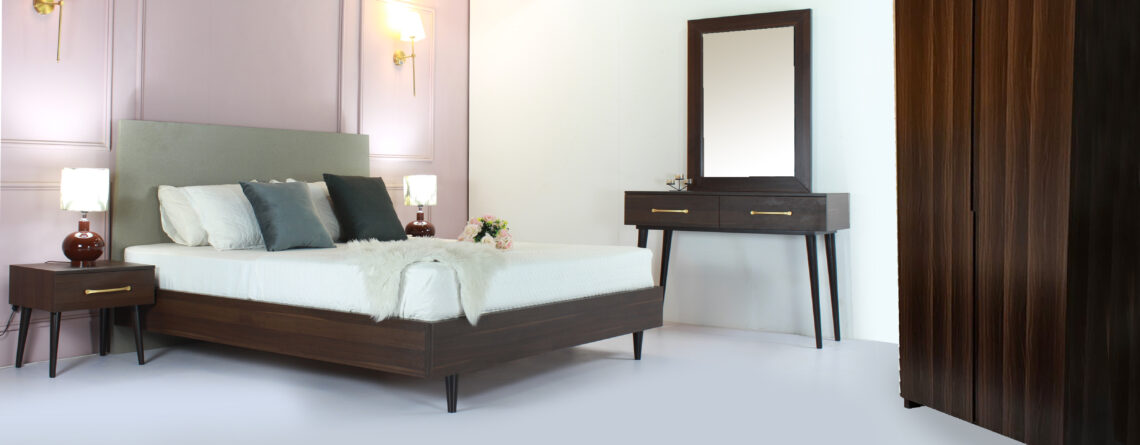 "Bedroom furniture set featuring a patterned bed, two side tables, one dresser, one mirror, and a two-door goof wardrobe – available in Karachi."