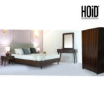 "Bedroom furniture set featuring a patterned bed, two side tables, one dresser, one mirror, and a two-door goof wardrobe – available in Karachi."